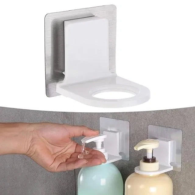 A Self Adhesive Shampoo Dispenser Bottle Rack for Bathroom Toilet Kitchen (Pack of 2) holds pump bottles on a tiled wall, letting you easily dispense soap into your palm with its secure, circular opening design.