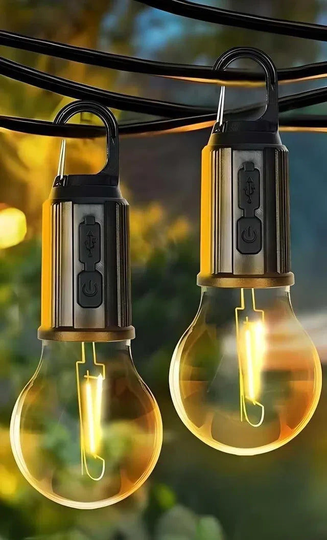 The Decorative Hanging Bulb with 3 Modes Tent Lamp for Camping (Pack of 2) features USB charging and a power button, glowing warmly when suspended outdoors—ideal as decorative tent lanterns for your next camping trip.