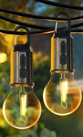 The Decorative Hanging Bulb with 3 Modes Tent Lamp for Camping (Pack of 2) features USB charging and a power button, glowing warmly when suspended outdoors—ideal as decorative tent lanterns for your next camping trip.